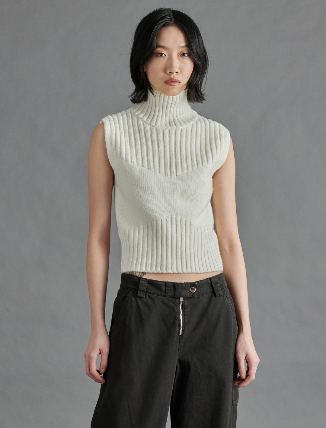 Model wearing Steve Madden's serin sweater in cream.