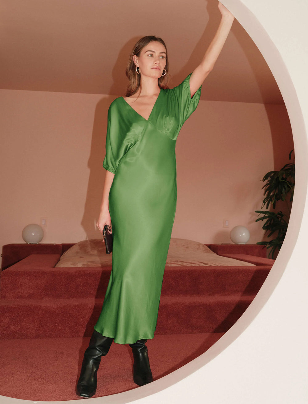 Model wearing Nation LTD's lily-rose dress in salon green.