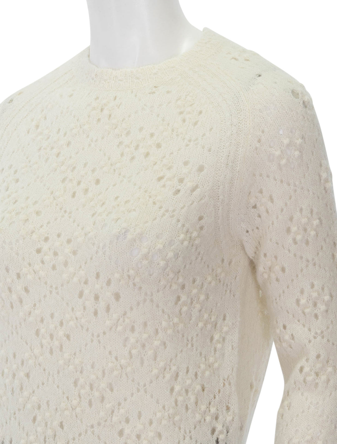 Close-up view of Doen's emiliana sweater in ivory.