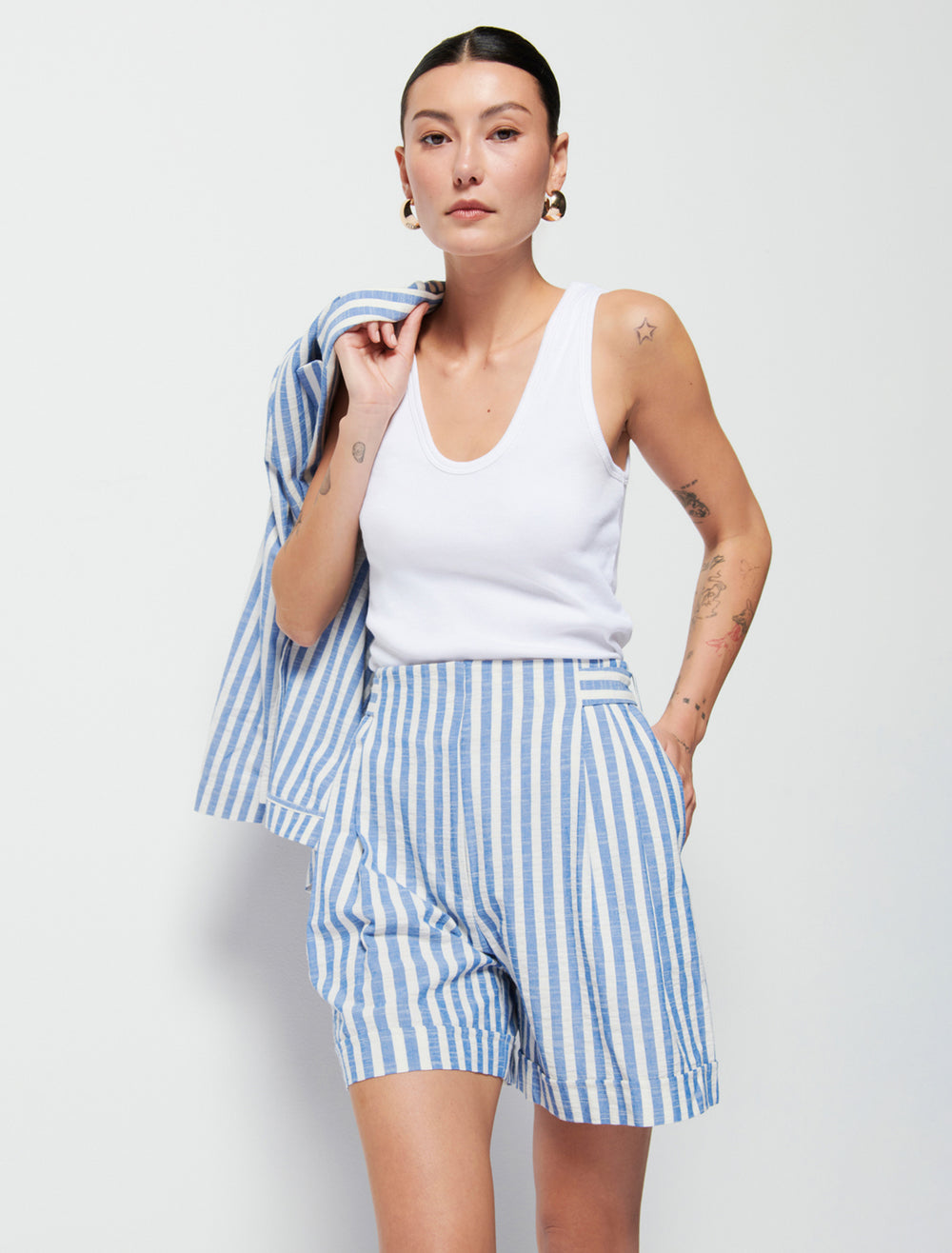 Model wearing Nation LTD's maja stripe short in parisian blue stripe.