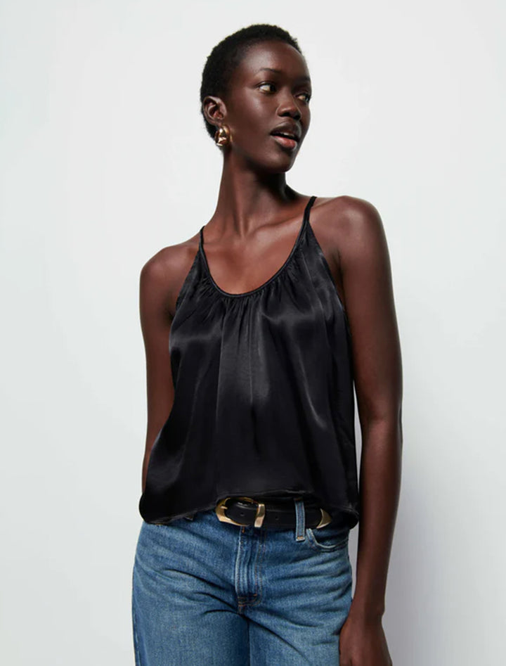 Model wearing Nation LTD.'s lily hammered satin top in black.