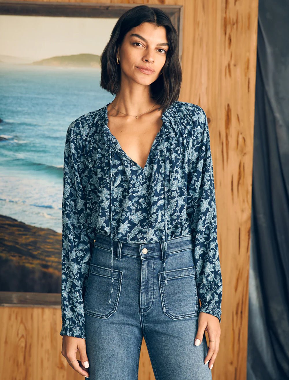 Model wearing Faherty's emery blouse in blue esna floral.