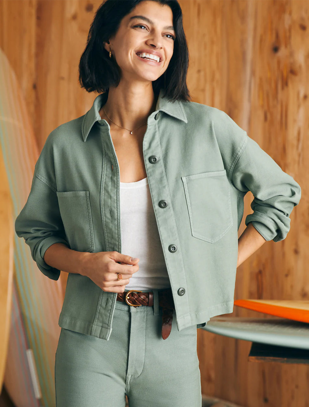 Model wearing Faherty's stretch terry overshirt in coastal sage.