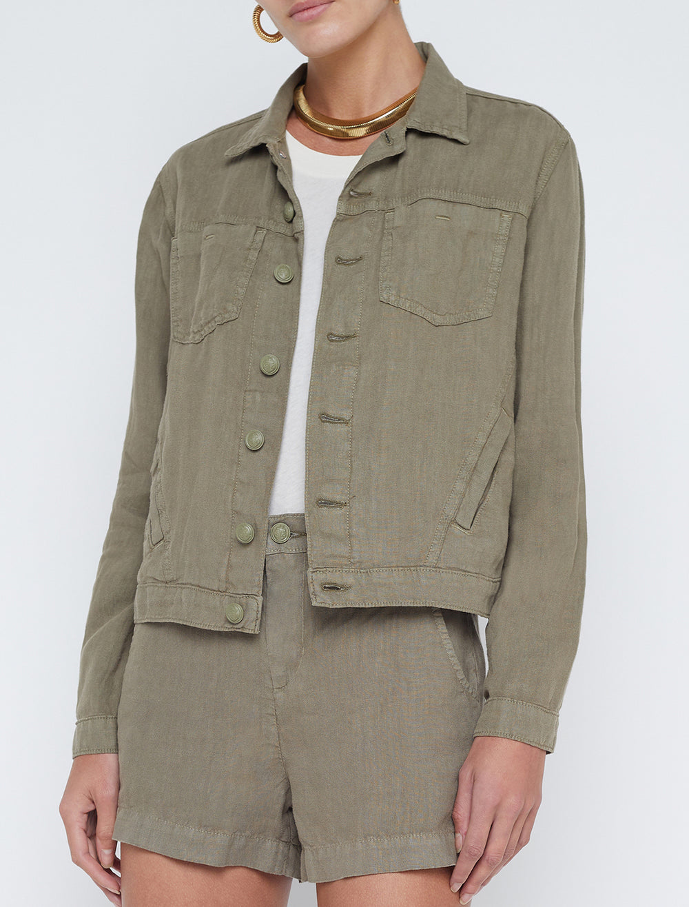 Model wearing L'agence's celine slim femme jacket in covert green.