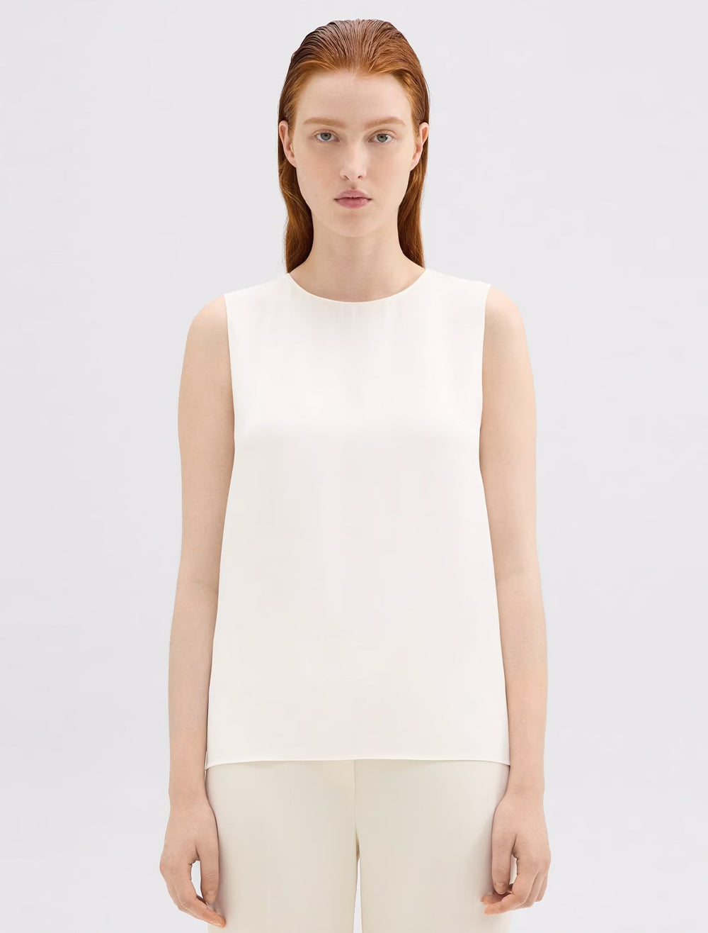 Model wearing Theory's the sleeveless shell in ivory.