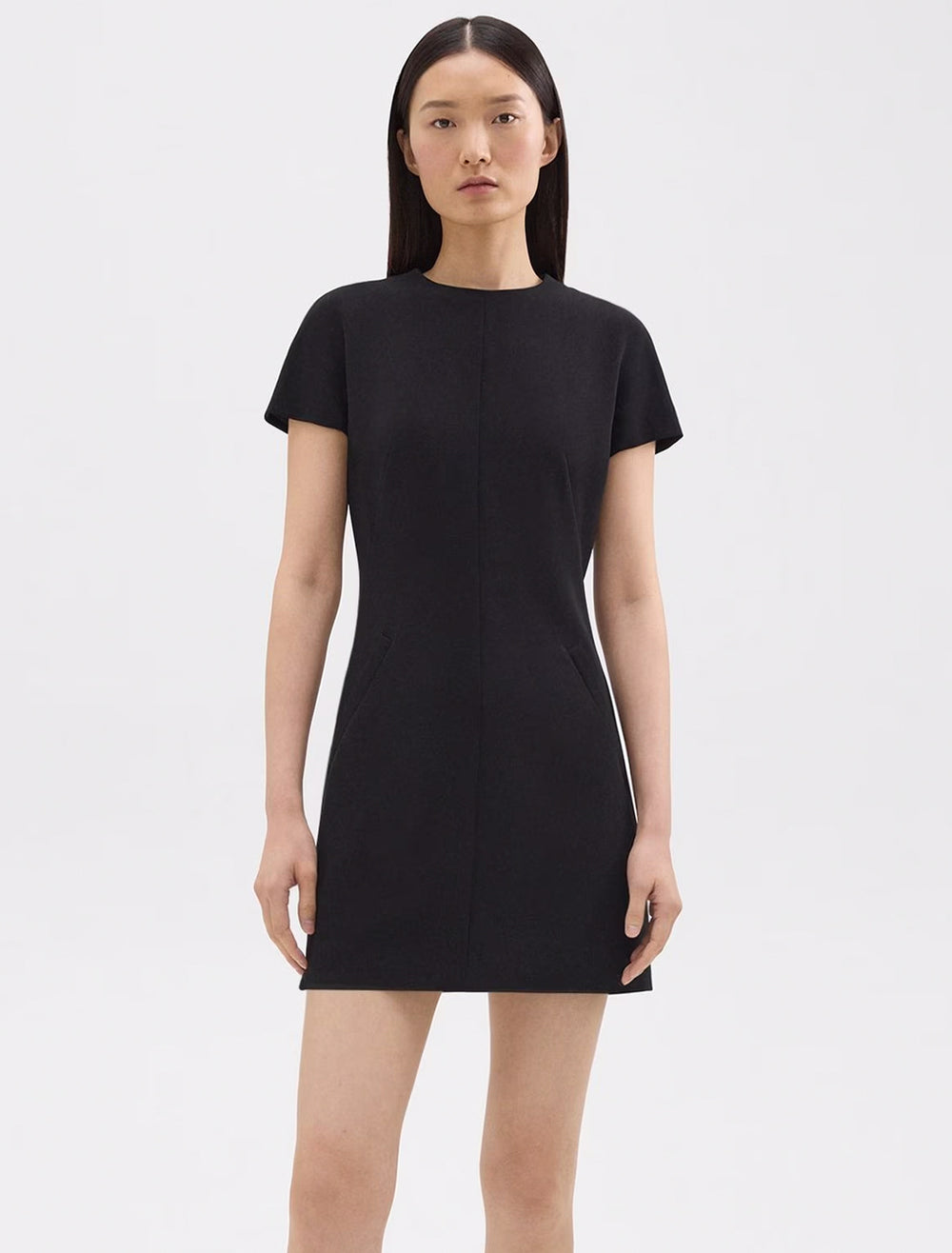 Model wearing Theory's dolman short sleeve admirable crepe dress in black.