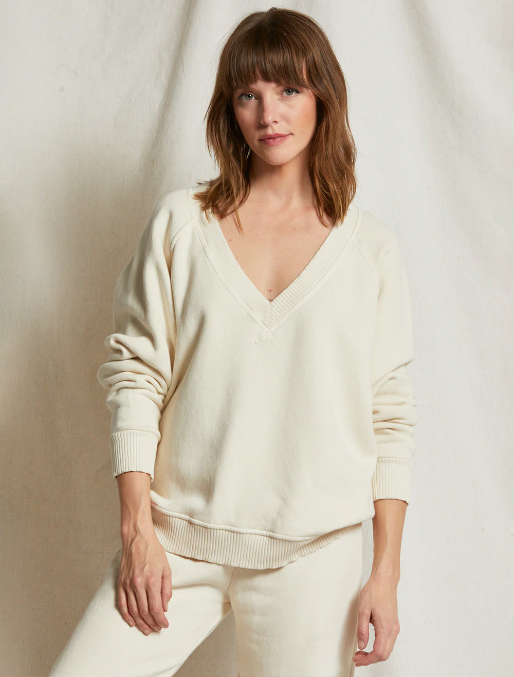 Model wearing Perfectwhitetee's dakota v-neck sweatshirt in sugar.