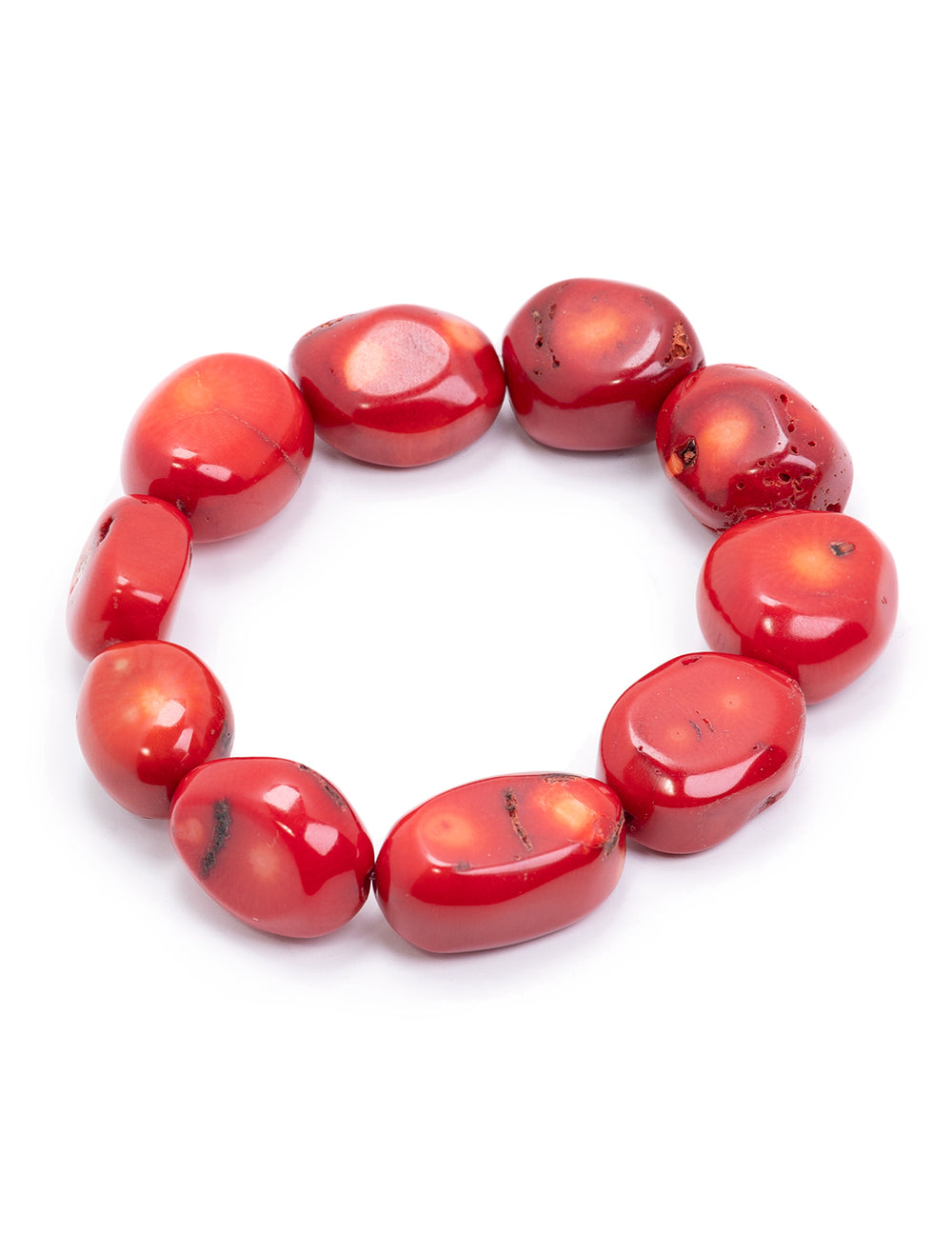 Close-up view of AV Max's red coral nugget bracelet.