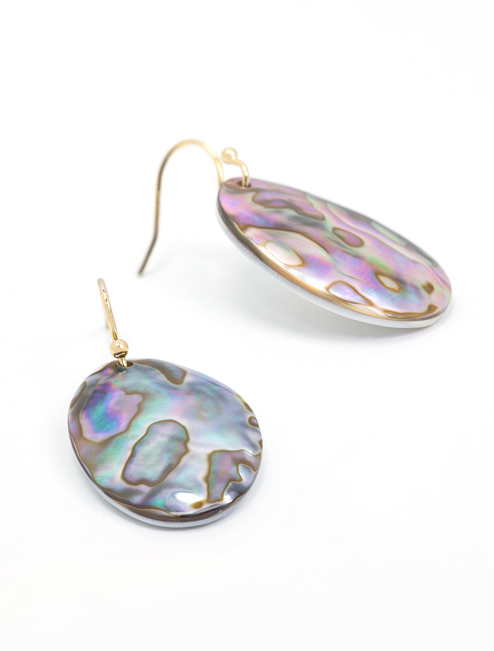 Close-up view of AV Max's organic abalone and mother of pearl earrings.