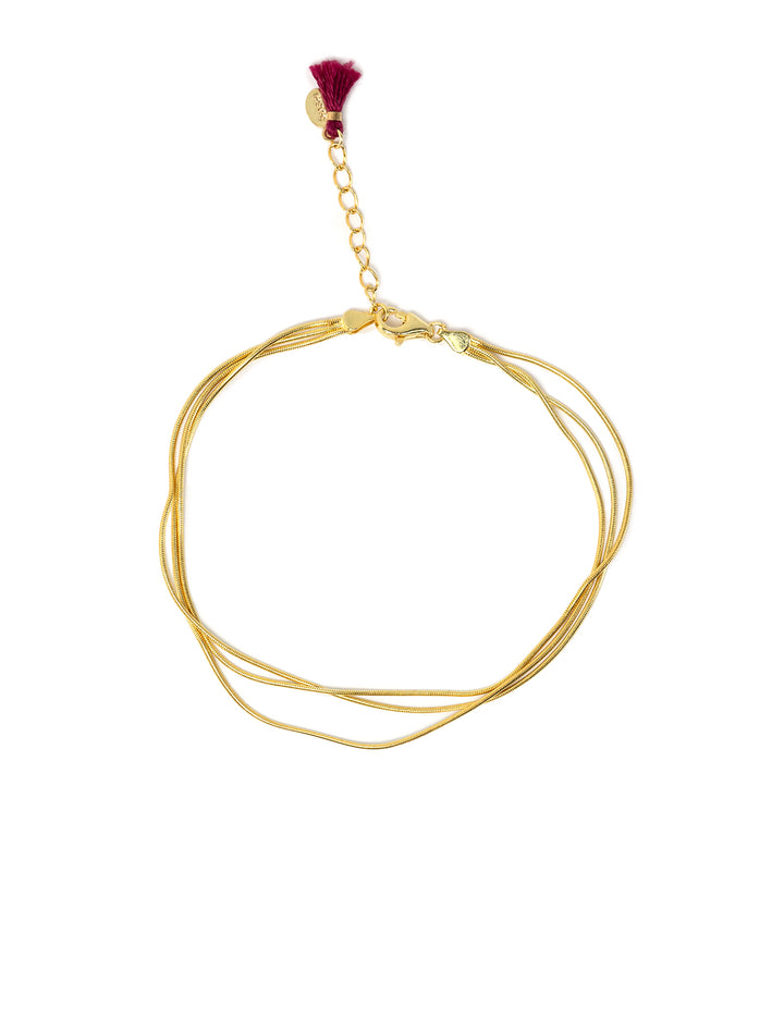 Overhead view of Shashi's sonara bracelet in gold.