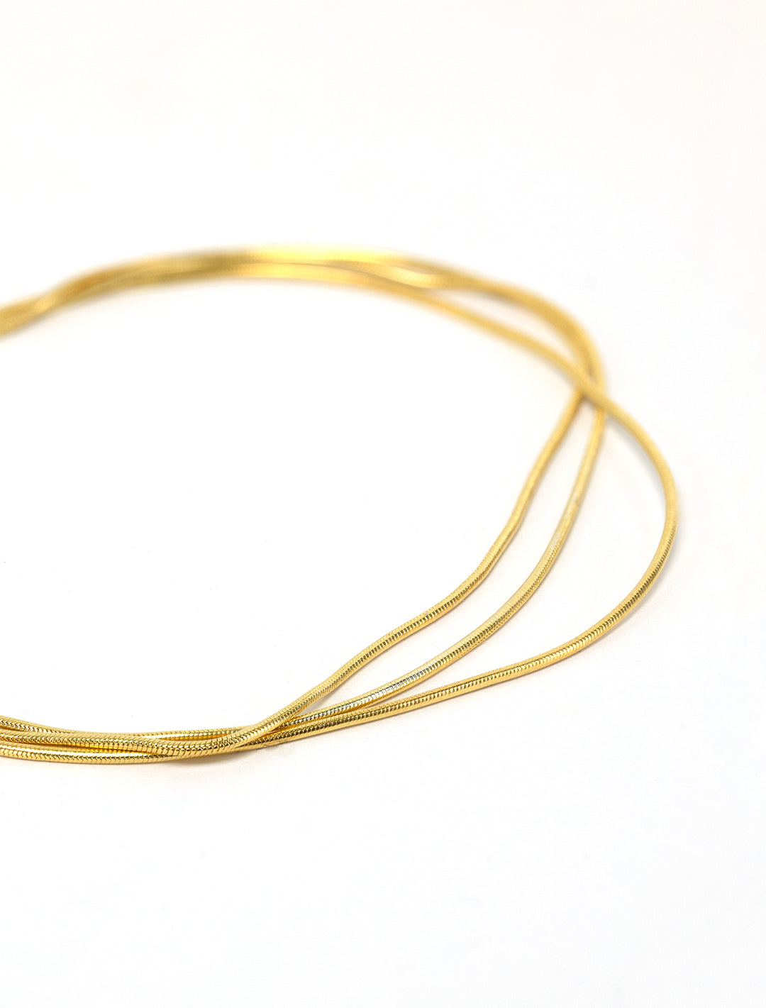 Close-up view of Shashi's sonara bracelet in gold.