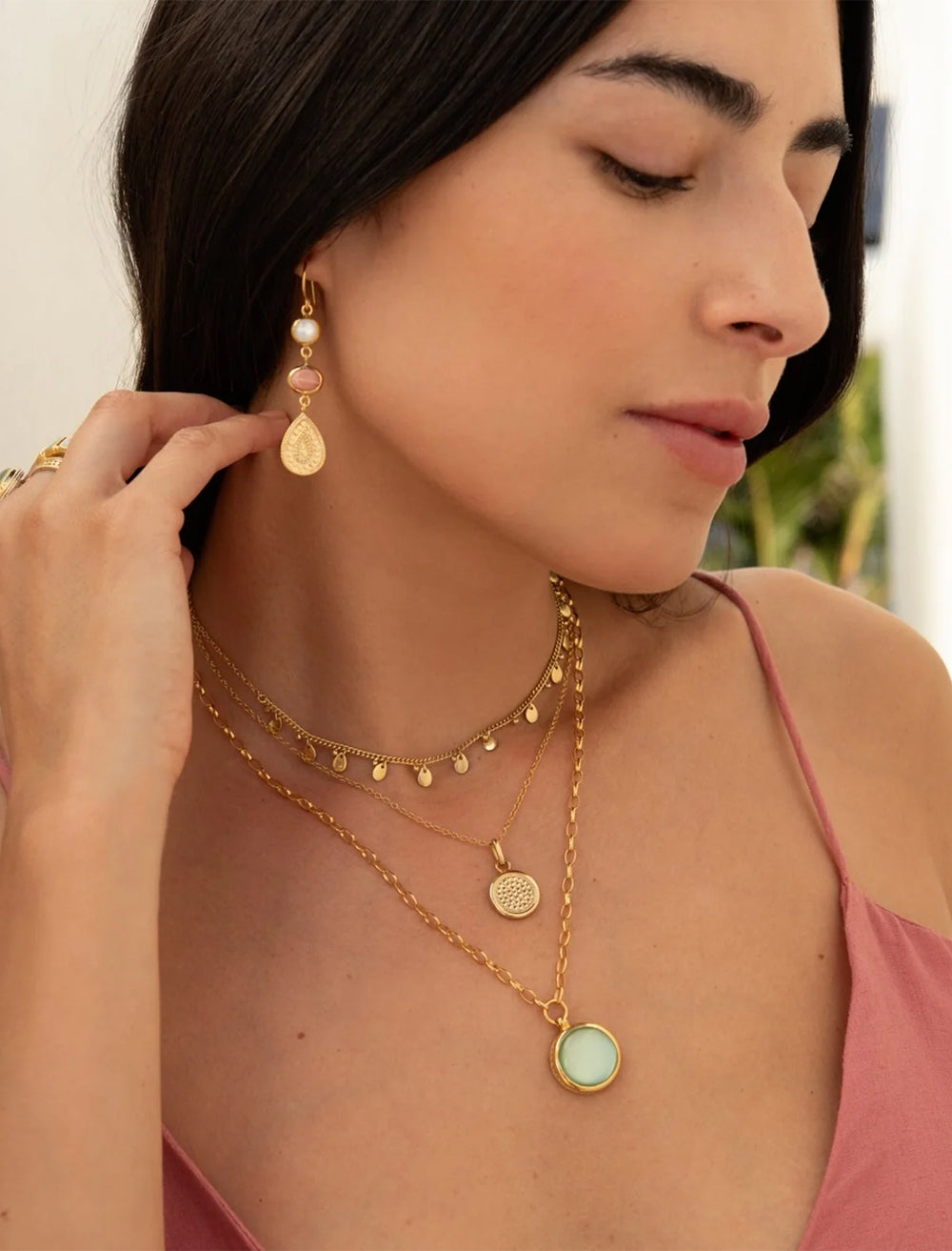 model wearing pink opal and mop triple drop earrings in gold