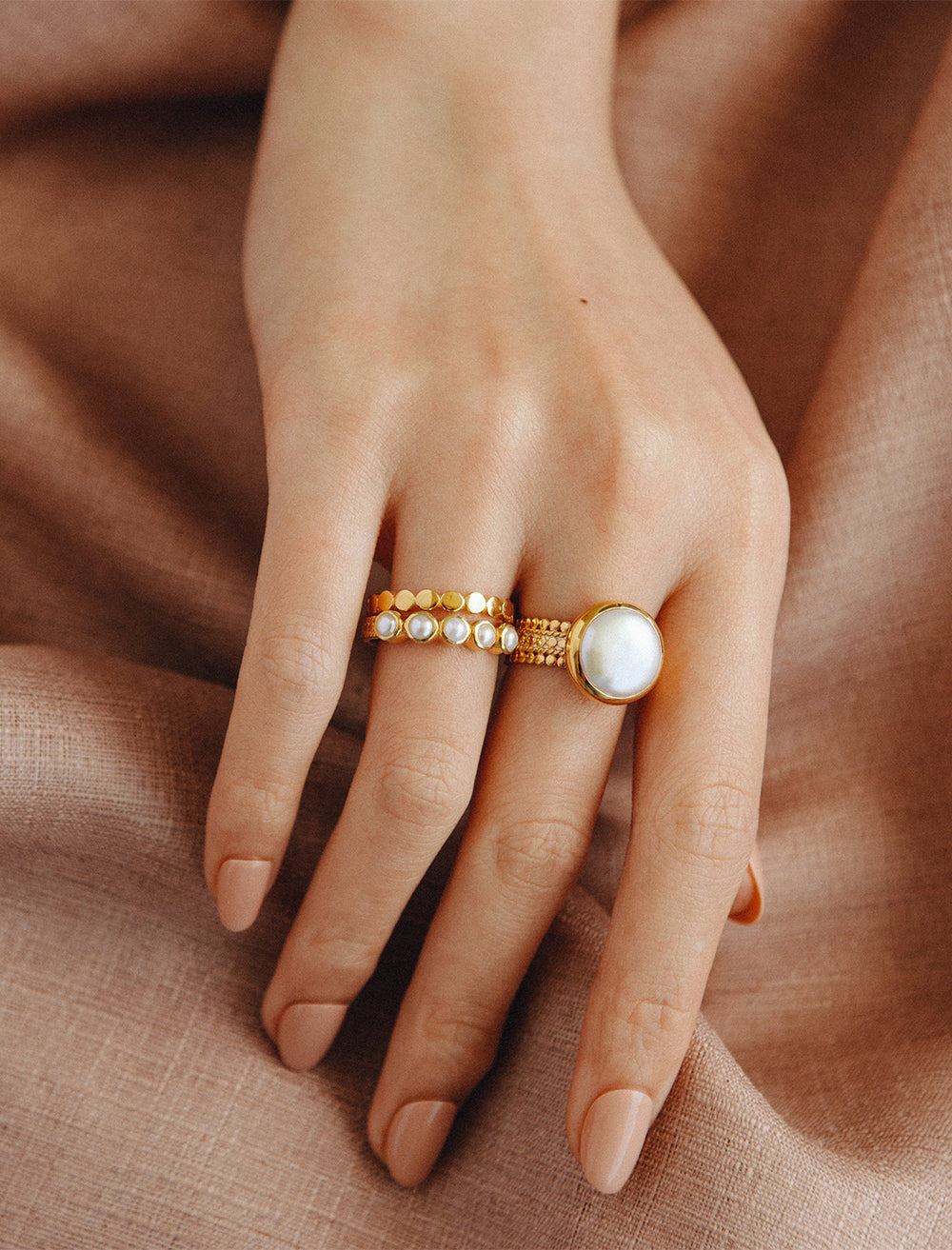 model wearing gold multi pearl ring