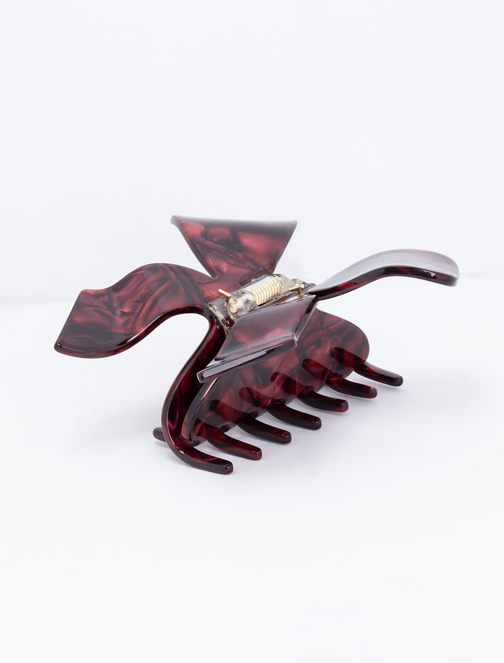 Side angle view of MLE's bow hair claw in burgundy.