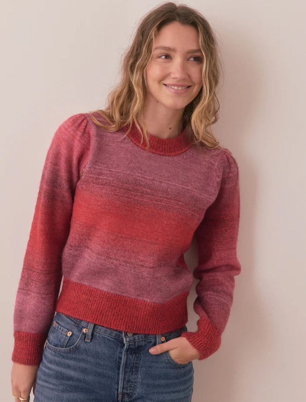 Model wearing Marine Layer's alma puff sleeve sweater in warm ombre.