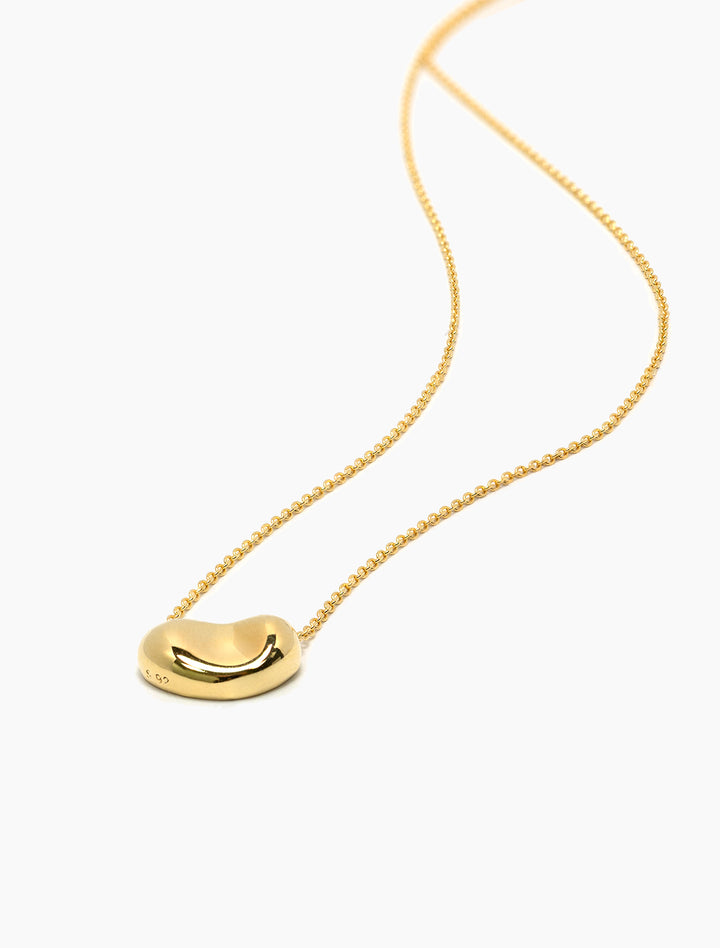 Close-up view of Tai's Gold Vermeil Bean Pendant Necklace.