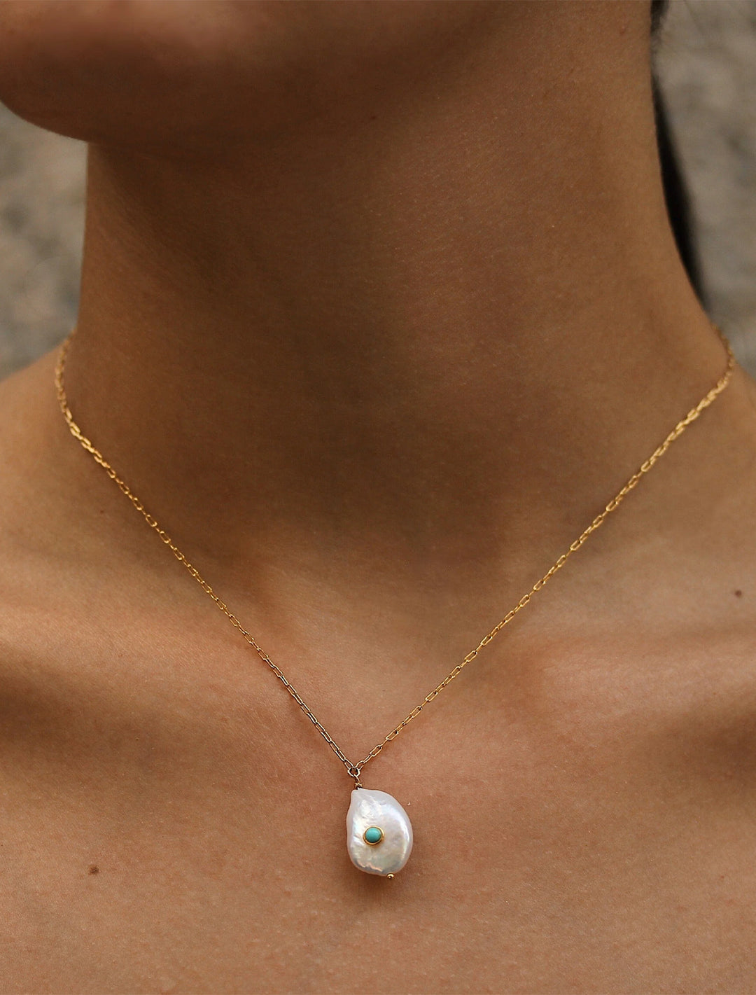 model wearing freshwater pearl necklace with turquoise bezel accent