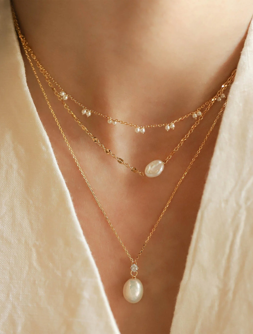 model wearing organic pearl and cz pendant necklace in gold