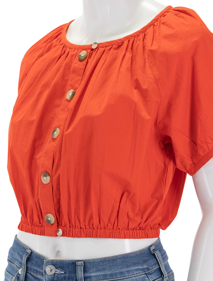 Close-up view of Lilla P's elastic hem button front top in poppy.