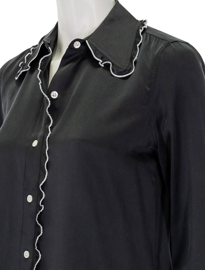 Close-up view of Rails' fia top in black with white piping.