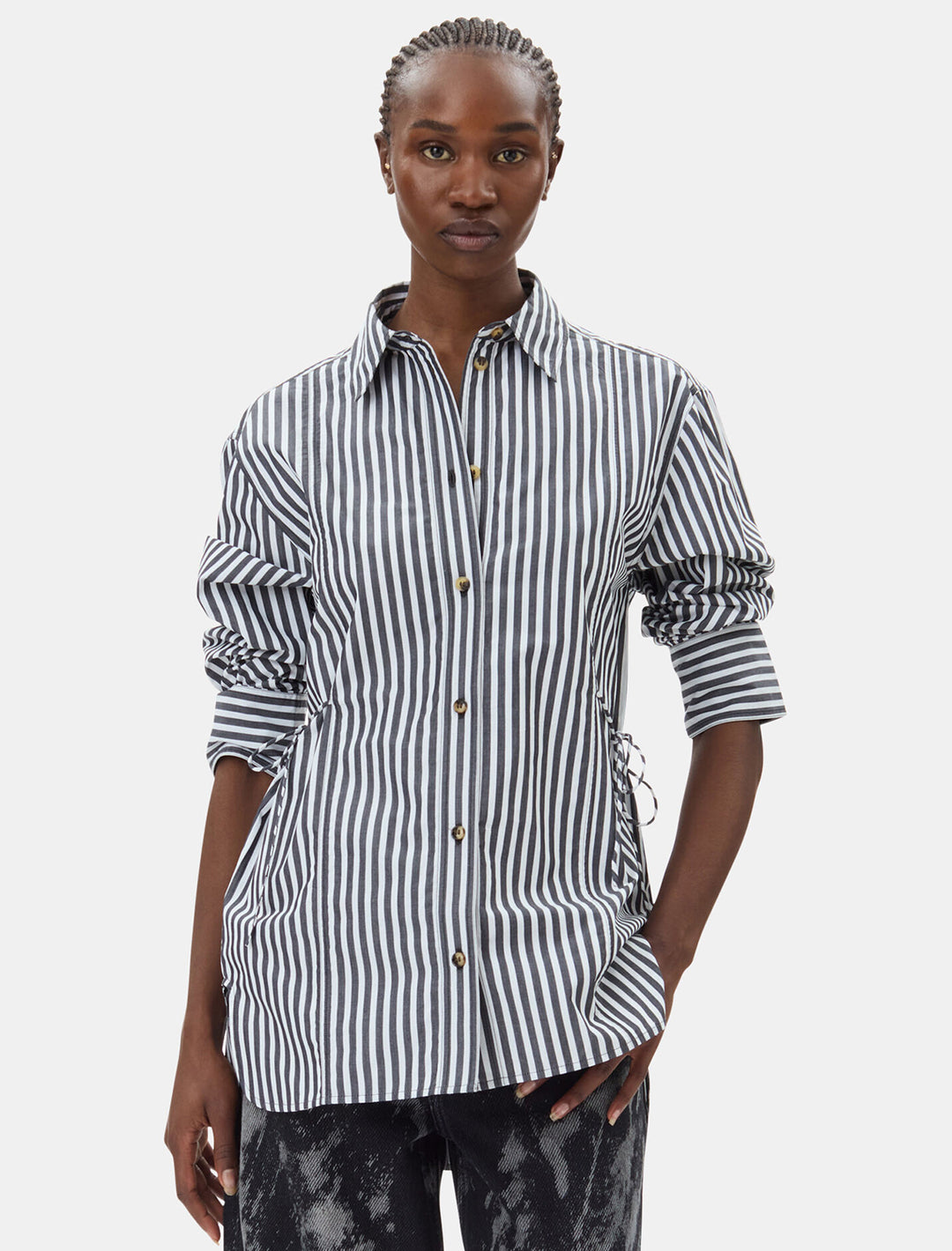 Model wearing GANNI's stripe cotton oversized tie string shirt.