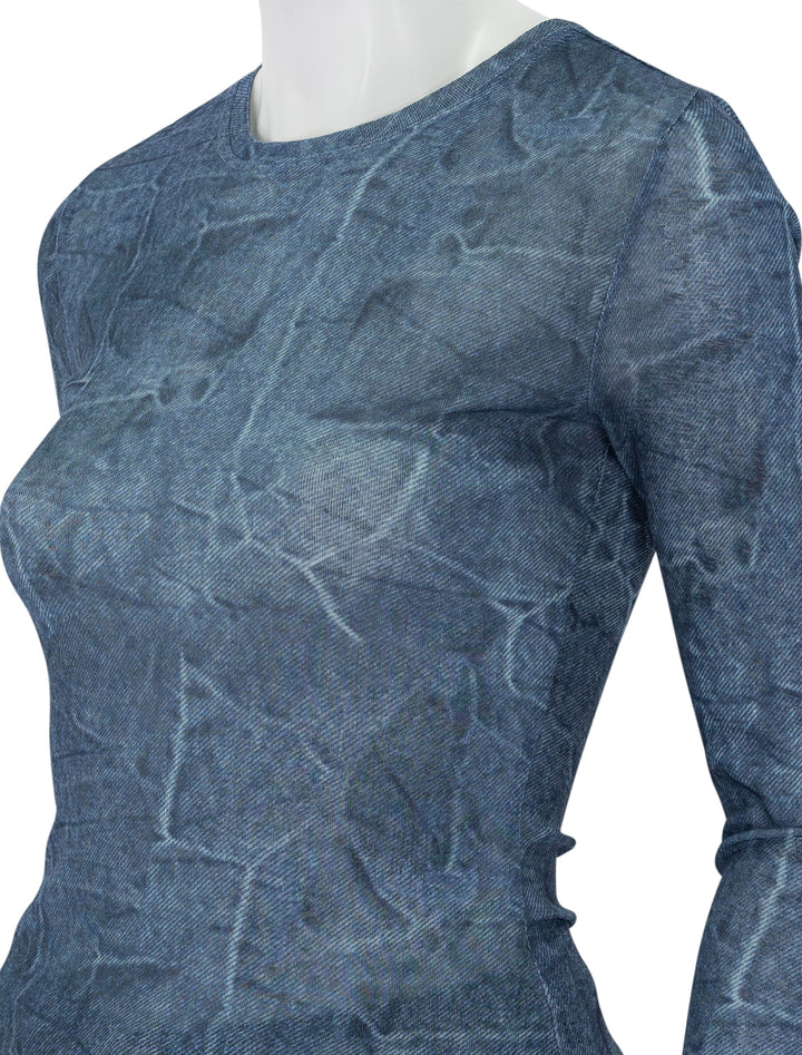 Close-up view of GANNI's marl mesh long sleeve crew neck blouse in denim.