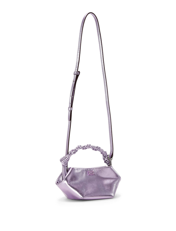 Front angle view of GANNI's mini bou bag in pink lavender metallic with strap extended