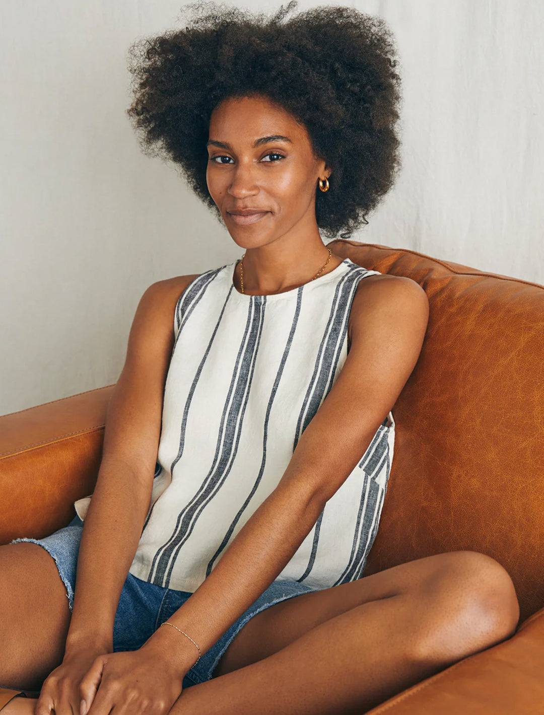 Model wearing Faherty's shoreline shell in santa cruz stripe.