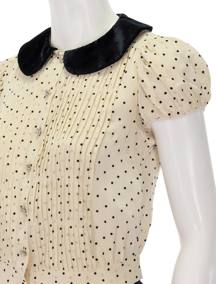 Close-up view of Doen's madeline top in mother of pearl dot.