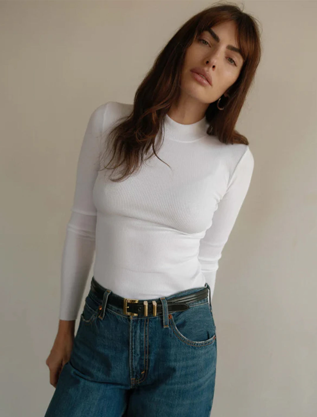 Model wearing Nation LTD's gina slim mock neck in white.