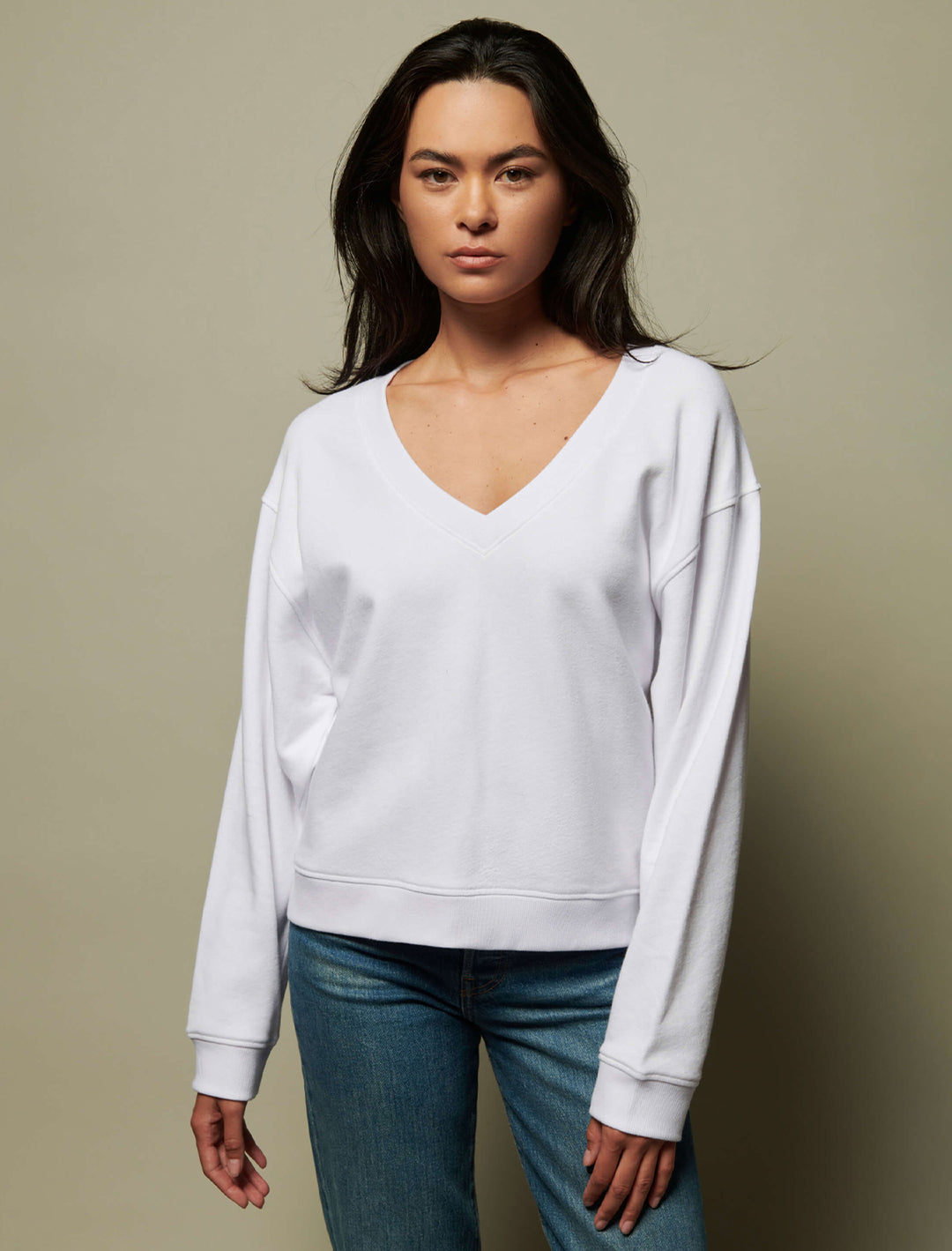 Model wearing Nation LTD's wyatt oversized vneck in white.