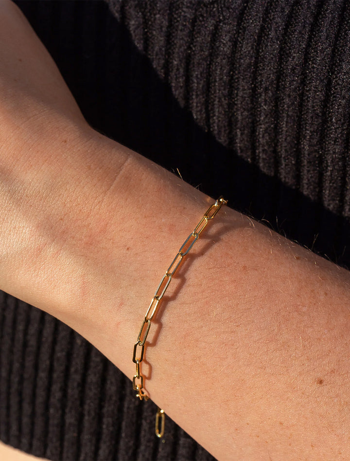 Model wearing Thatch's finn bracelet in gold.