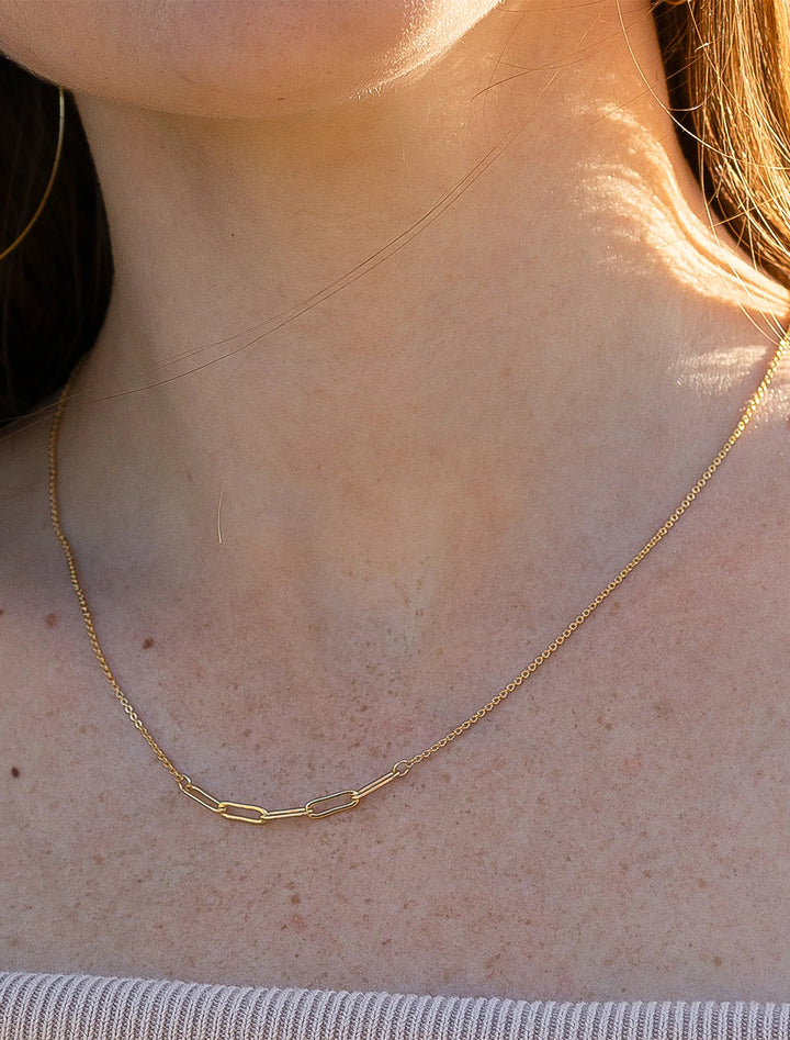 Model wearing Thatch's cora necklace in gold.