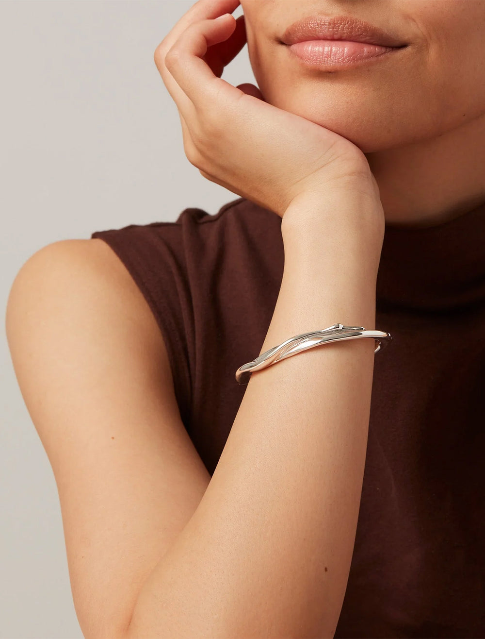 Model wearing Jenny Bird's colette bangle in silver.