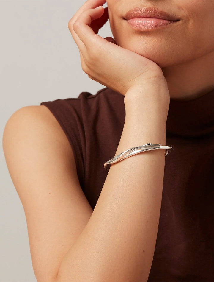 Model wearing Jenny Bird's colette bangle in silver.