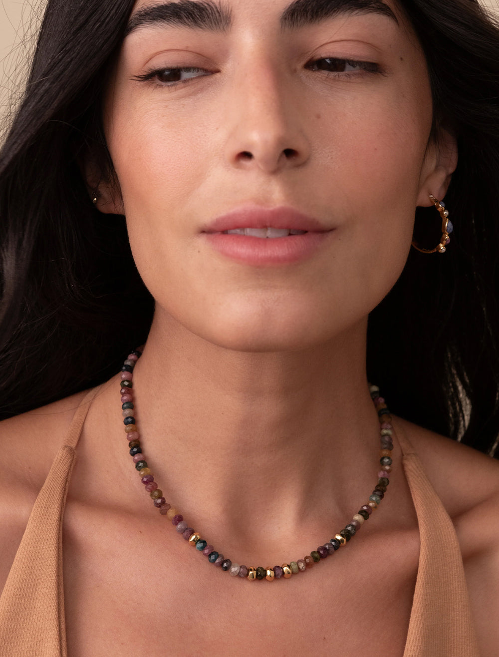 Model wearing Anna Beck's beaded tourmaline necklace with gold bead accents.