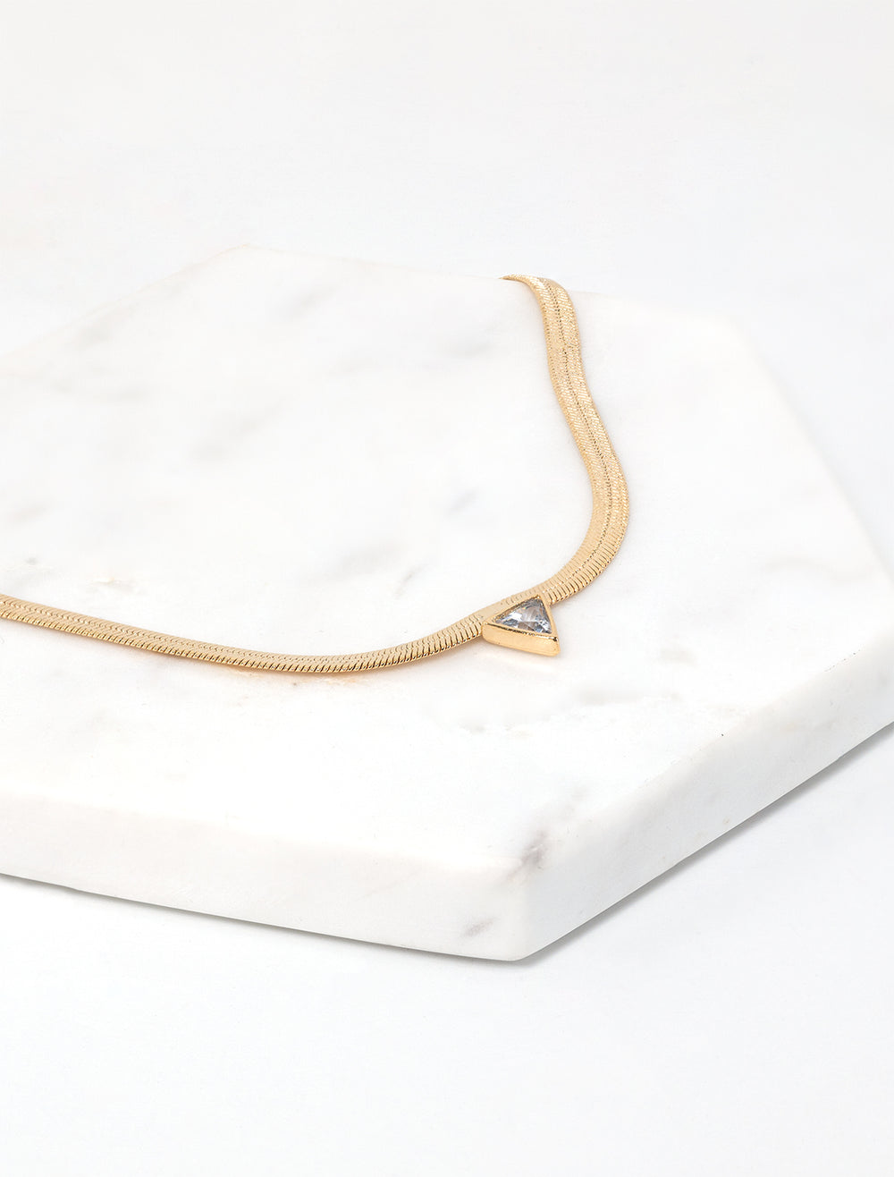 Laydown view of Jonesy Wood's kenna necklace in gold.