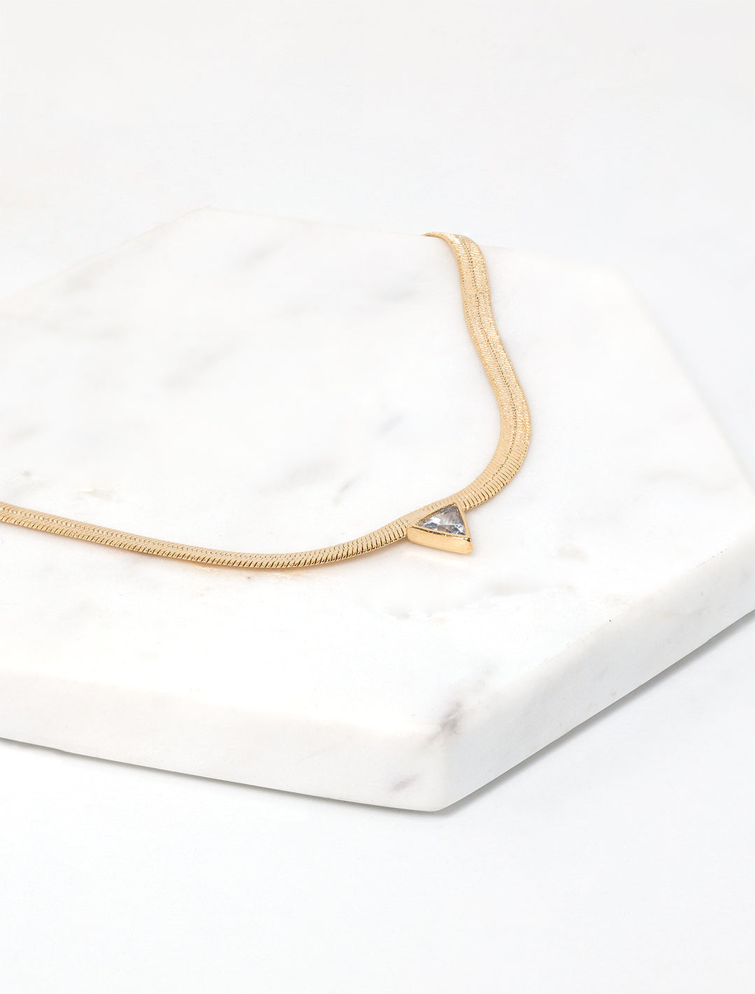 Laydown view of Jonesy Wood's kenna necklace in gold.