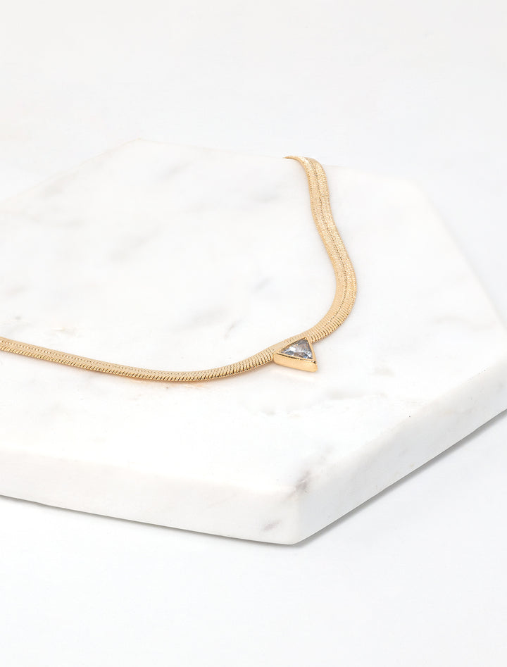 Laydown view of Jonesy Wood's kenna necklace in gold.