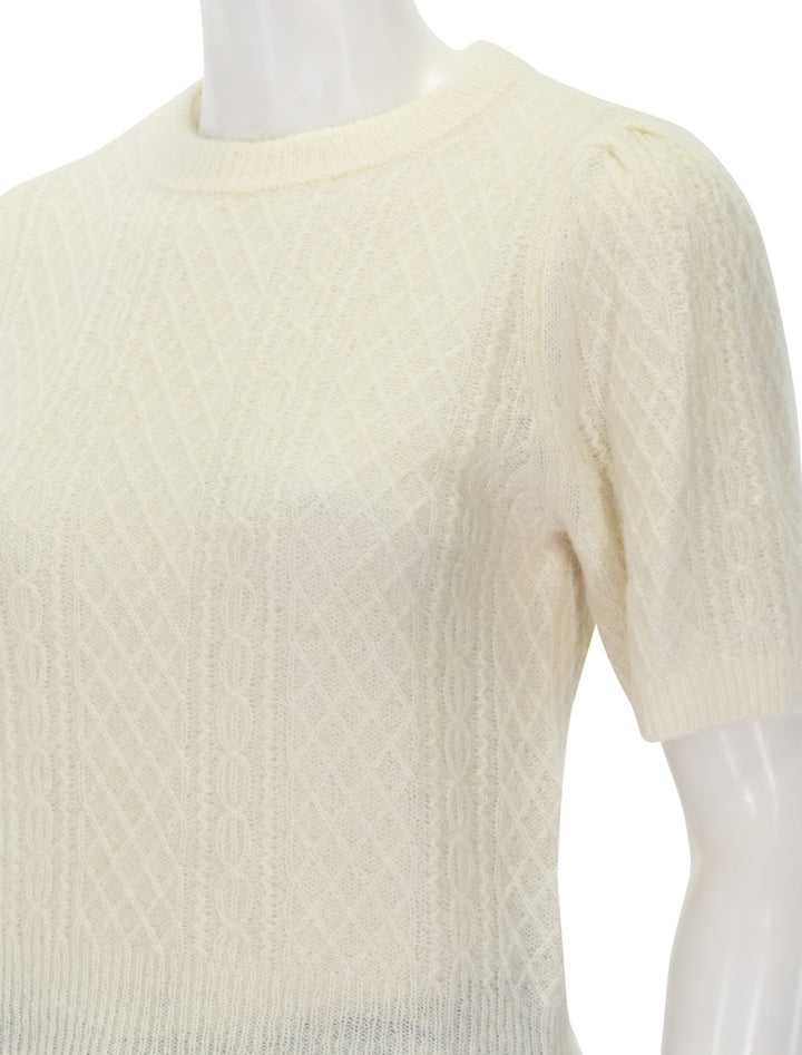 Close-up view of Lilla P.'s cropped cable sweater in ivory.