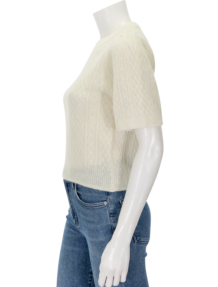 Side view of Lilla P.'s cropped cable sweater in ivory.