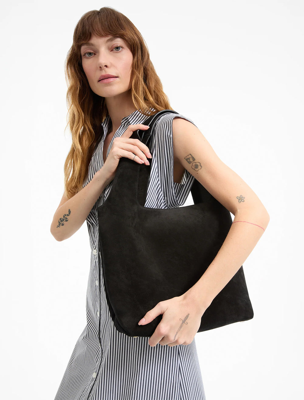 model holding sling bag in black