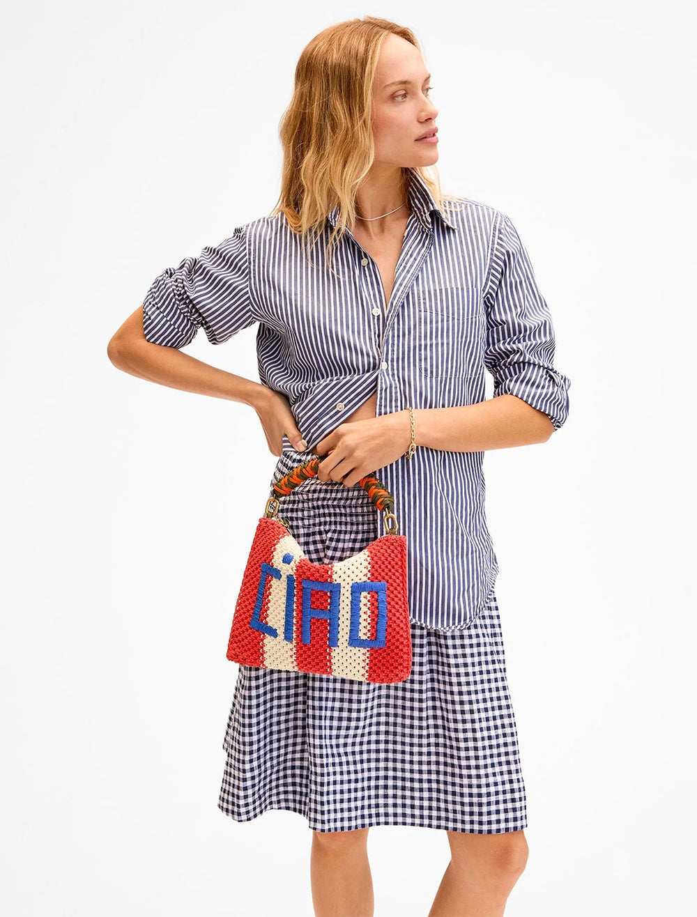 model wearing flat clutch with tabs in cream and poppy with ciao