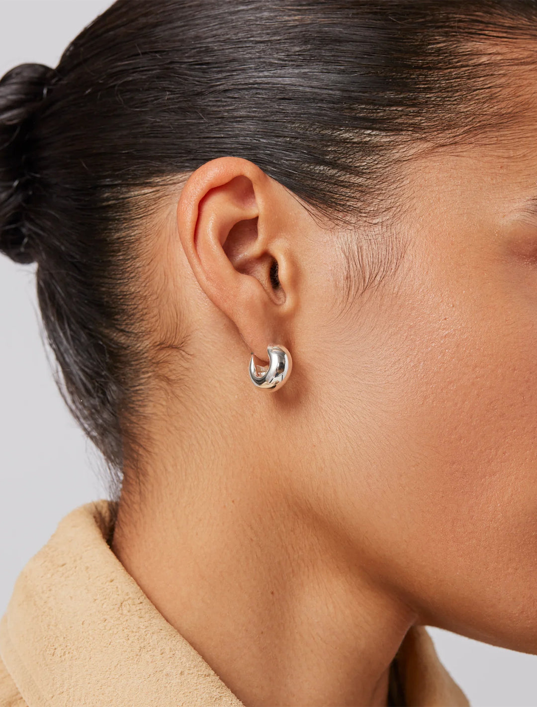 model wearing mini tome hoops in silver