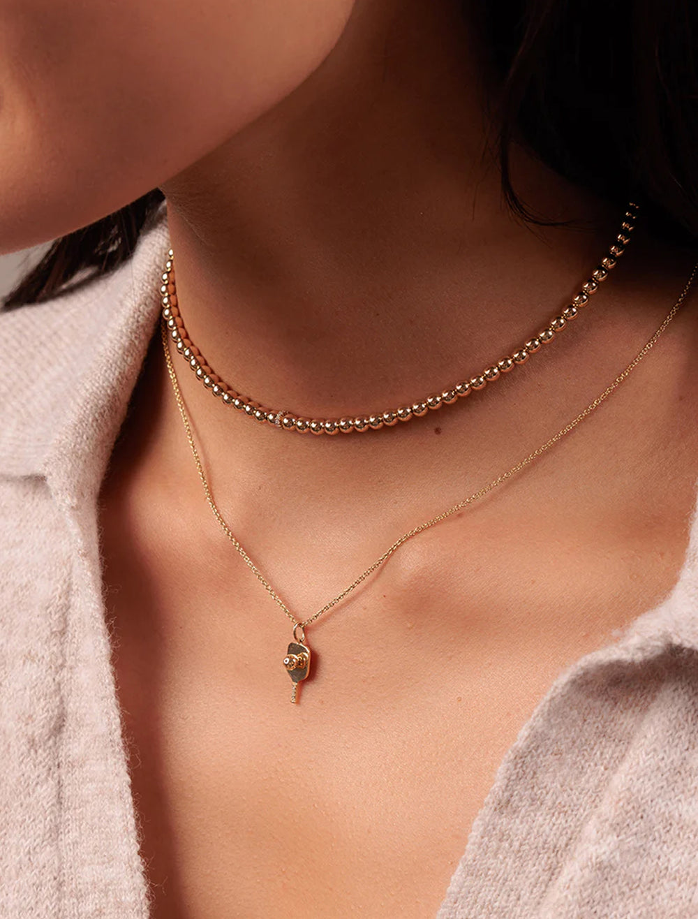 model wearing gold and diamond rondelle necklace