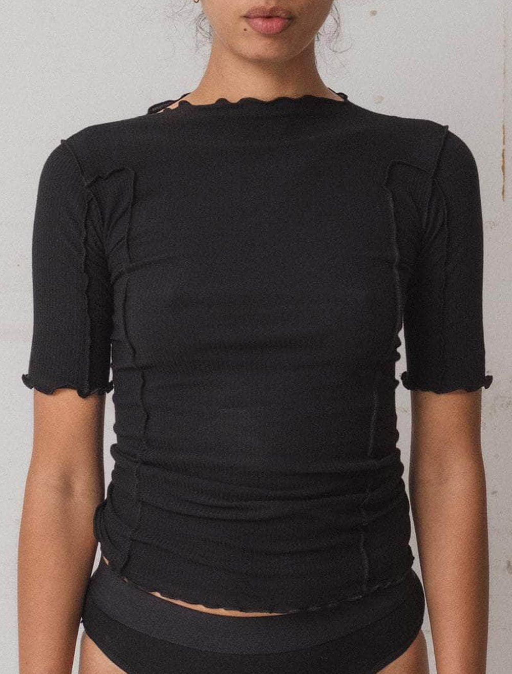 model wearing omato 3/4 sleeve tee in black