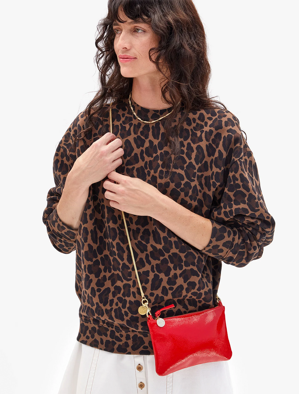model holding super red pucker patent wallet clutch