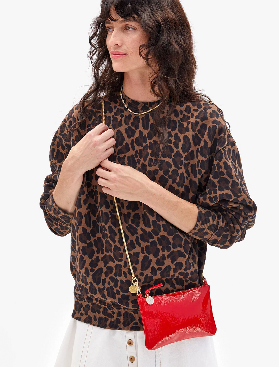 model holding super red pucker patent wallet clutch