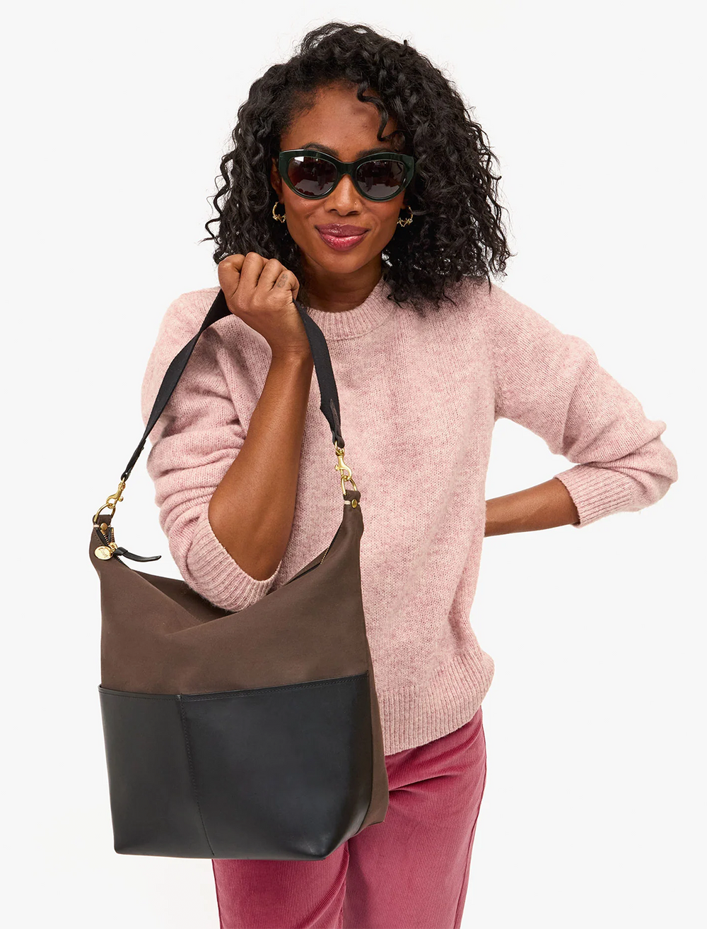 model holding sophie canvas and leather tote in kalamata and black