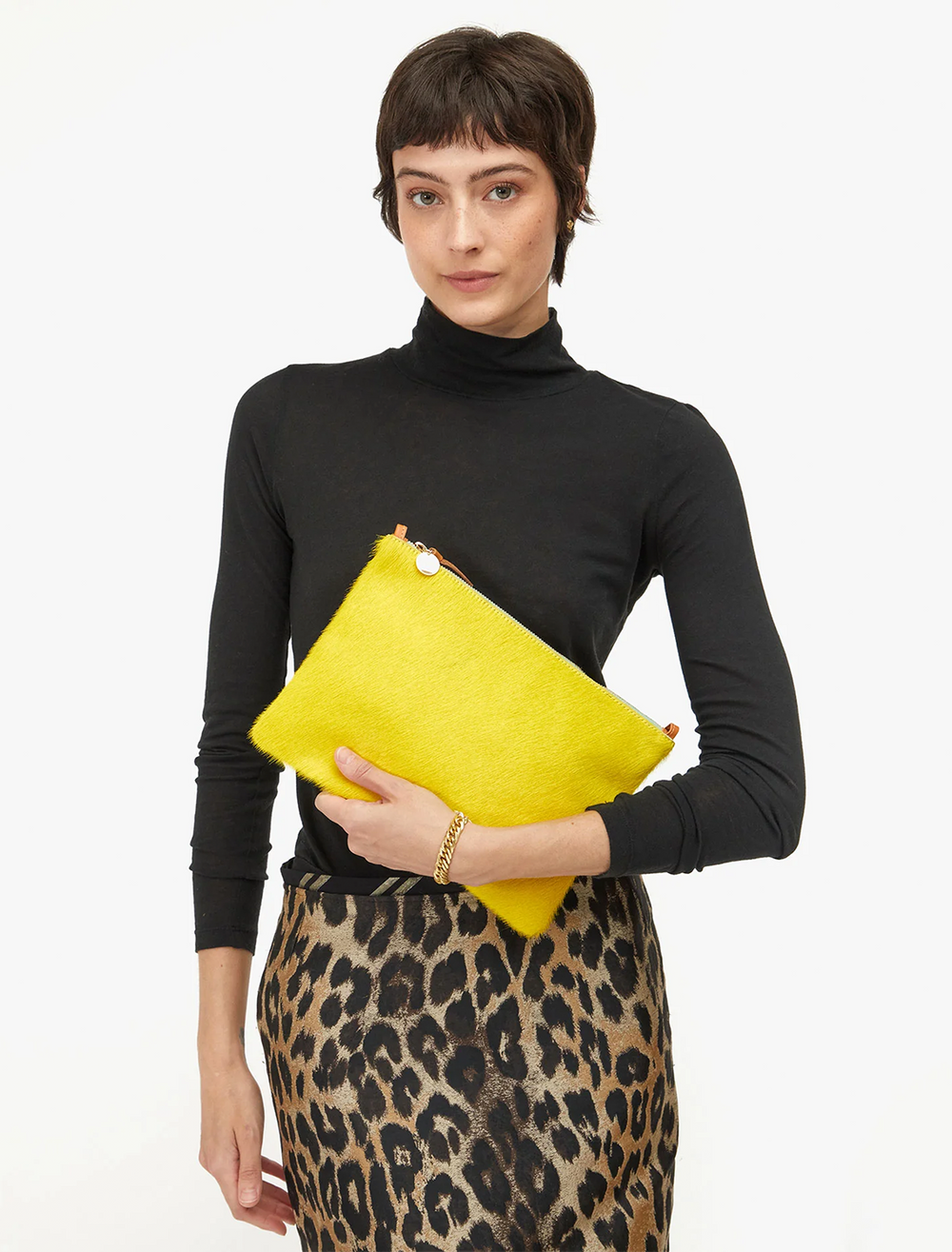 model holding citron hair calf flat clutch with tabs
